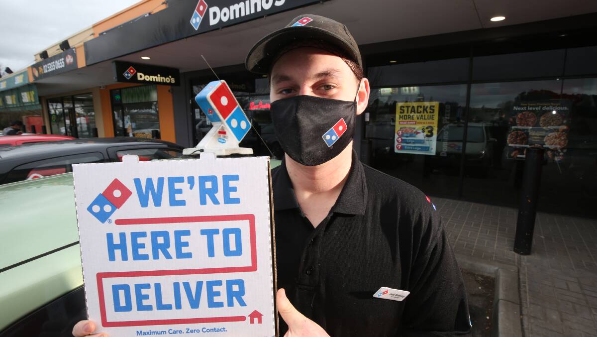 PIZZA PICK-UP: Jack Gunning from Dominos with one of the pizzas en-route to Covid testing staff at Mt Panorama.
