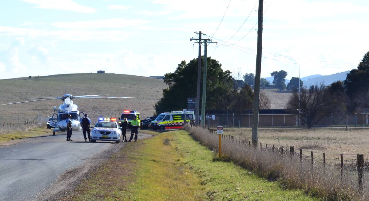 EMERGENCY: Police, paramedics and the Toll rescue helicopter at the scene of Monday's workplace incident at Raglan.