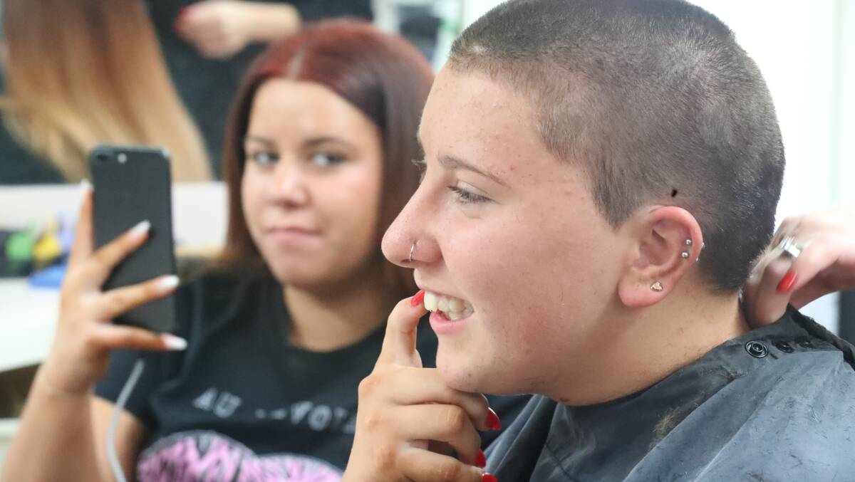 HEADSHAVE: Chloe and Tori (at rear) White at Chloe's head shave on Wednesday in support of her mum, Lou.