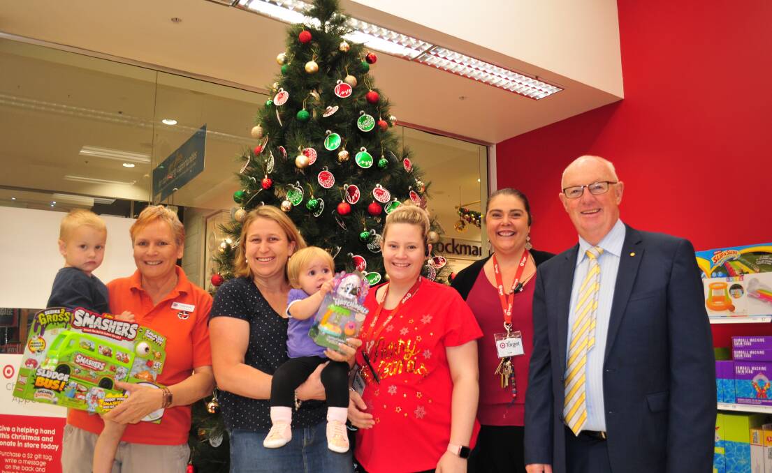 PLEASE DONATE: Julie Greig holding  Lachlan Wray, Robyn Wray holding Kenzie Wray, Kiri Allen (assistant manager), Lisa Morrison (manager) and Mayor Graeme Hanger 