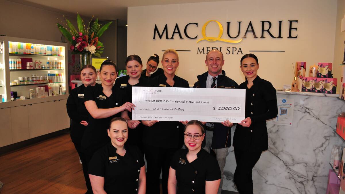 THANK YOU: Karla McDiarmid, with her medi spa staff present Ken Barwick with a cheque for $1,000 for Ronald McDonald House.