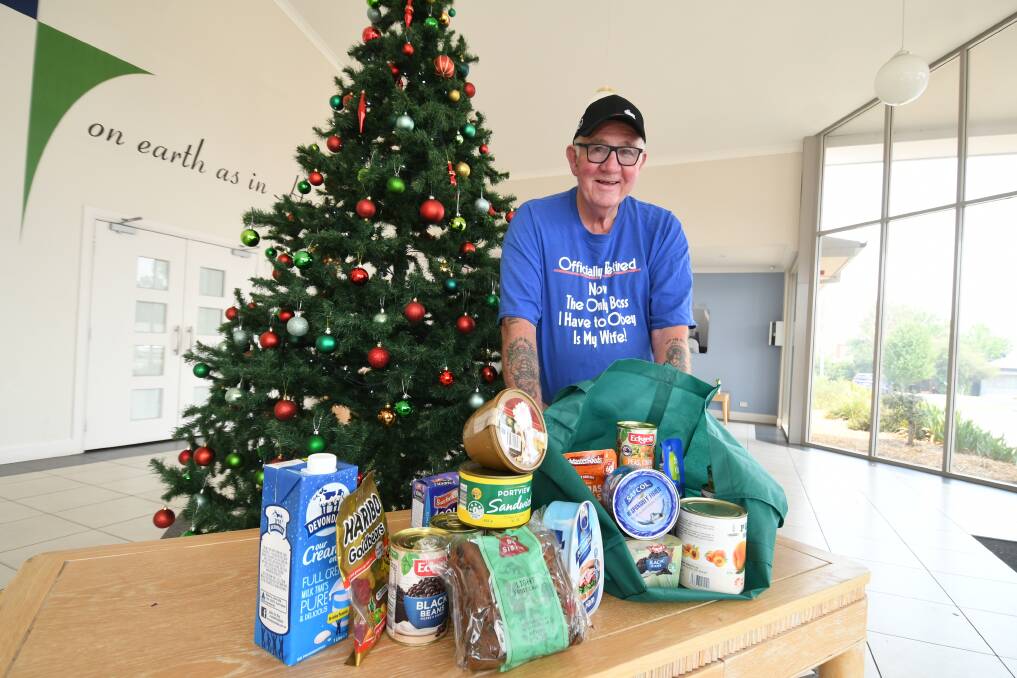 DONATIONS BEING TAKEN: Barney Rumble, with donations for the Christmas Day luncheon.