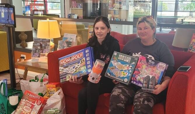 SHOW OF SUPPORT: Bathurst's Brittany Wood and Kimberly Benger with their bags of donations at Ronald McDonald House in Orange.