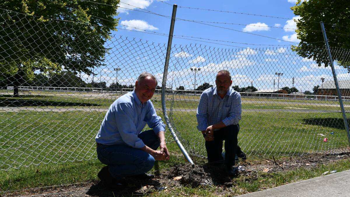 SAFETY CONCERNS: Andrew Fletcher, with Scott McLennan, pictured near the damaged fence. They are concerned for pedestrian safety.
