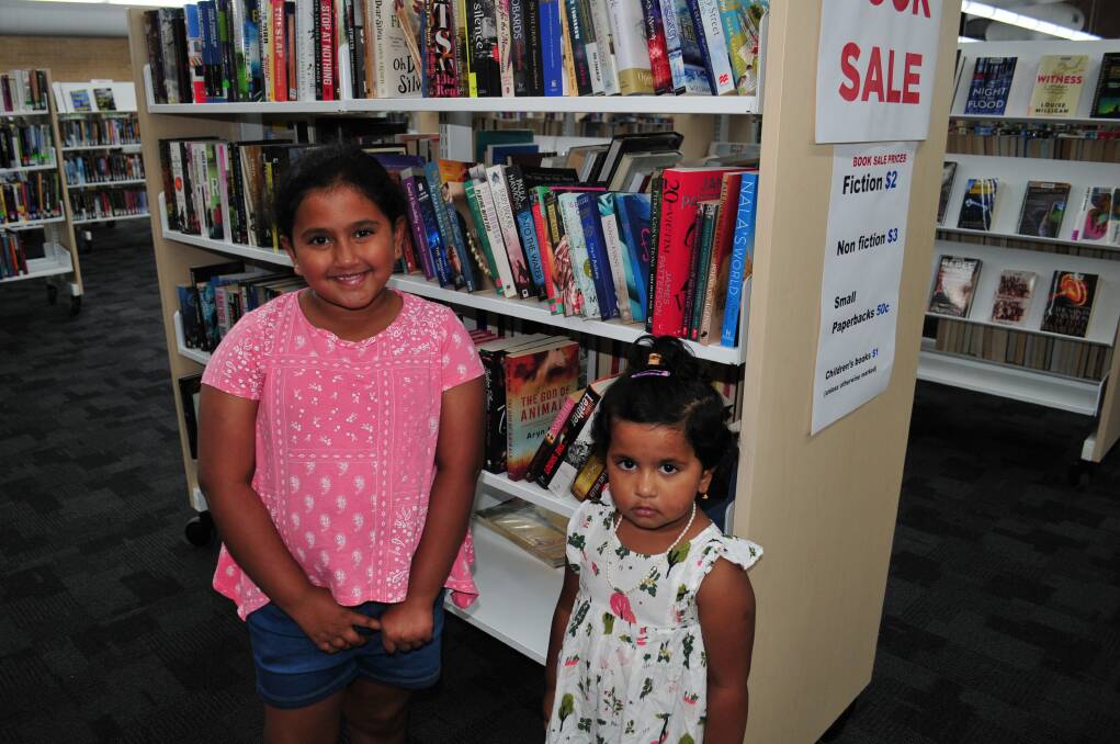 AT THE BOOK SALE: Nitha Mathew with Neha Mathew, looking at the titles available at the Bathurst Library book sale on Saturday afternoon.