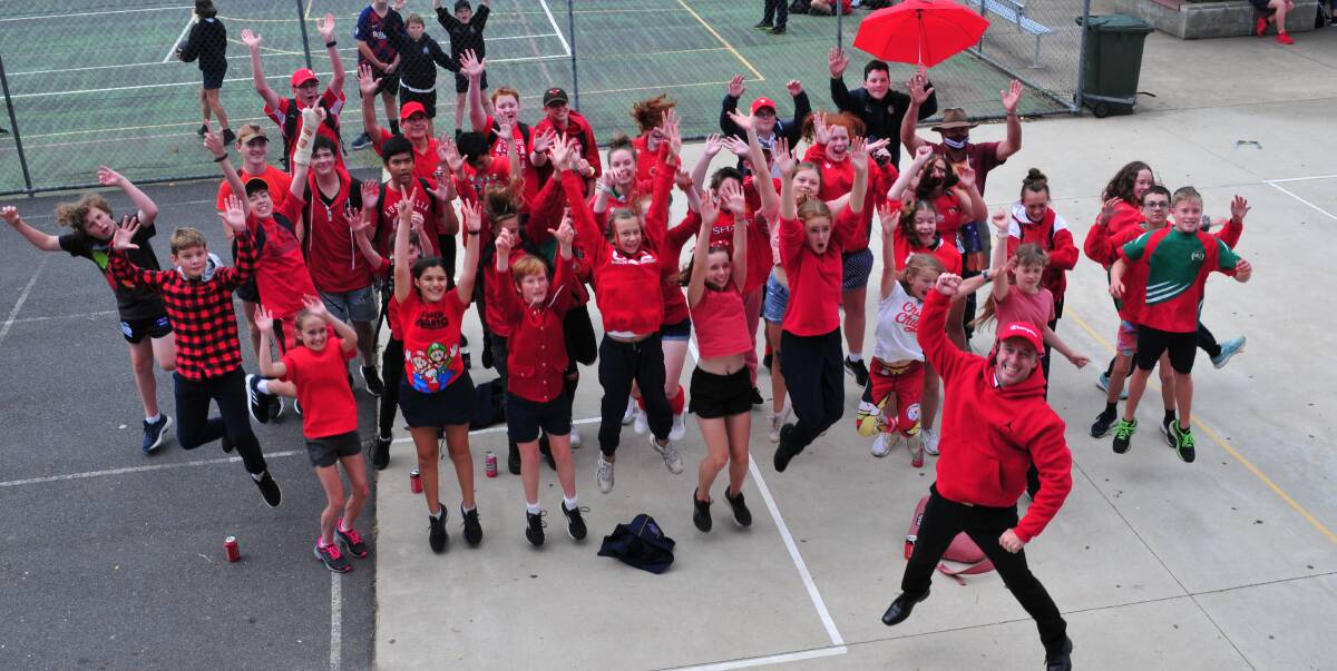 JUMPING FOR JOY: Ken Barwick, Principal of Bathurst High was ecstatic with the support shown to Wear Red Day, held on Thursday.