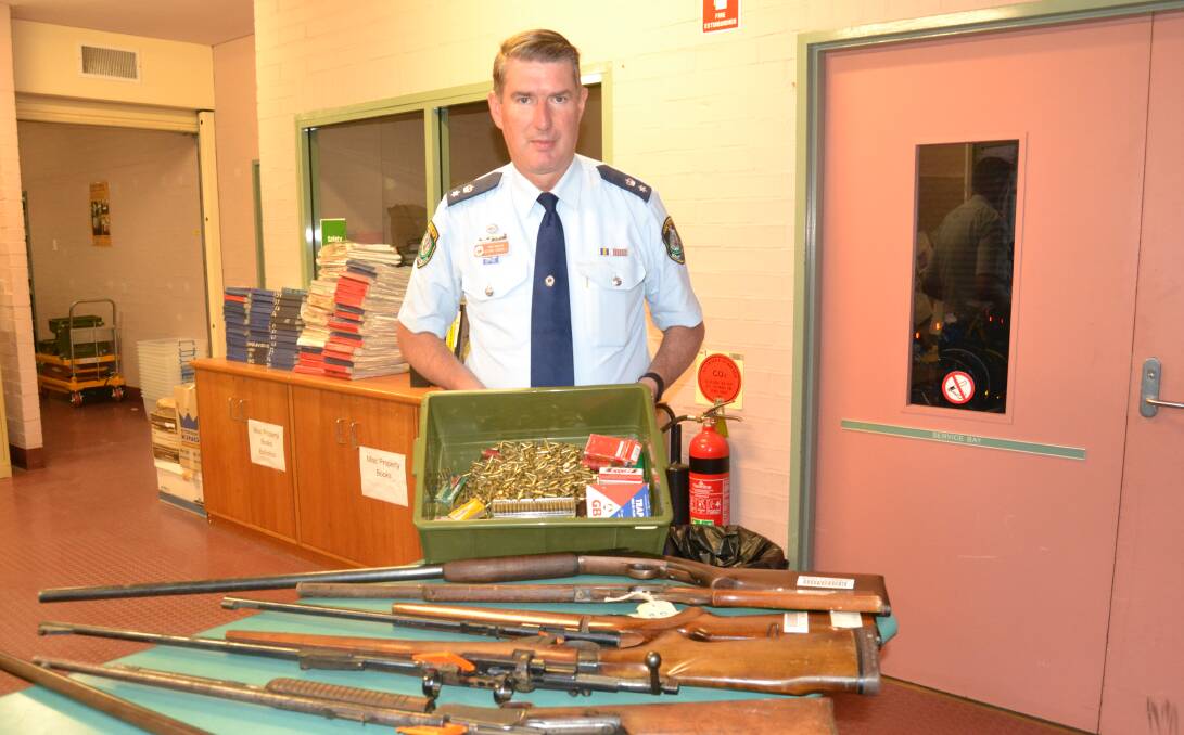 AMNESTY: Acting Superintendent Glenn Cogdell with firearms and ammunition handed in to Chifley local area command police as part of a national amnesty.