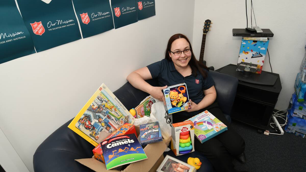 CAN YOU HELP? Emily Spindler ministry assistant, with items for this year's Salvos Christmas Appeal. The charity is expecting demand on services to spike at Christmas.