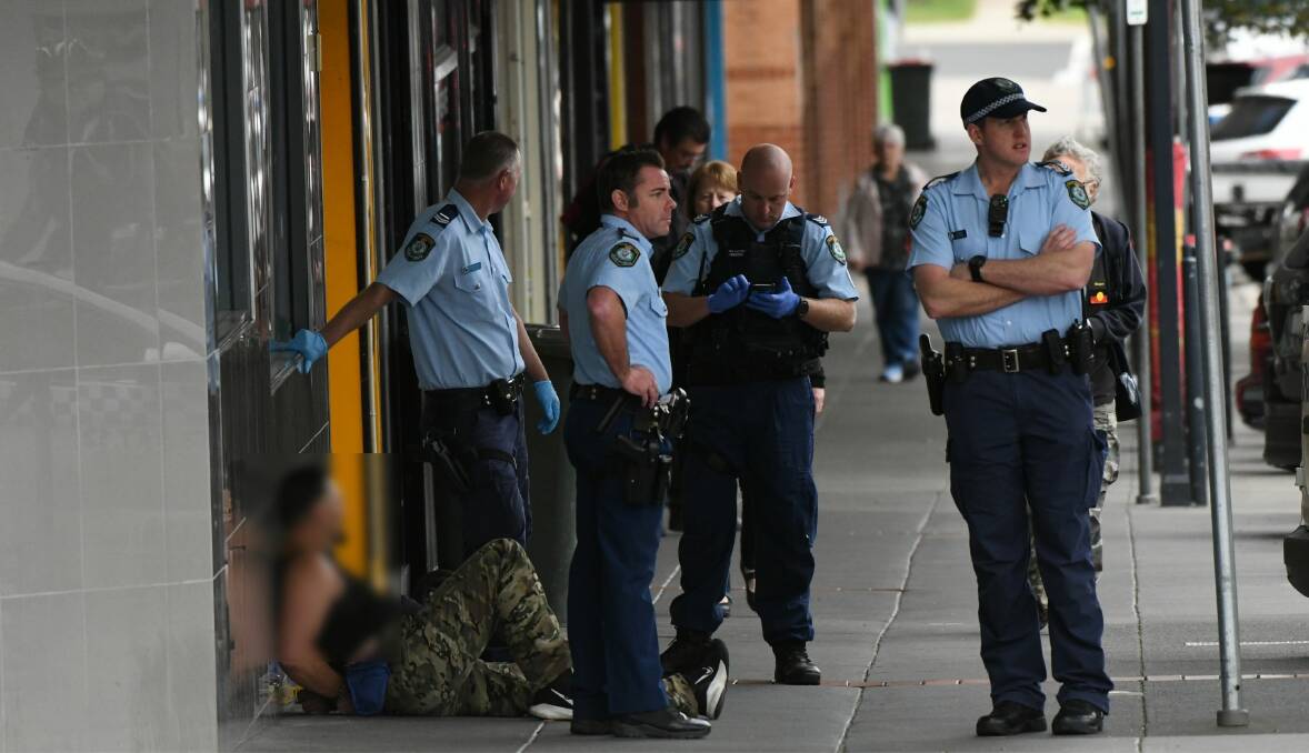 CBD RESPONSE: Police in William Street with a man who was later arrested following an incident on Tuesday morning.