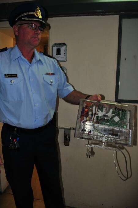 D WING: Bathurst Jail Governor Mark Kennedy holding a prison release television which is clear to prevent inmates from storing any contraband inside.