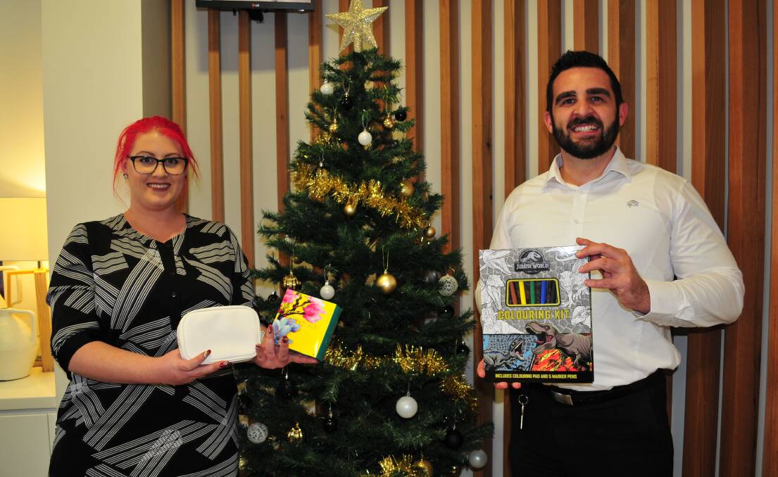 CHRISTMAS APPEAL: Cody Hancock, member service officer with Nathan Shaw, branch and lending manager, at Newcastle Permanent, are calling on Christmas donations for those struggling at Christmas.