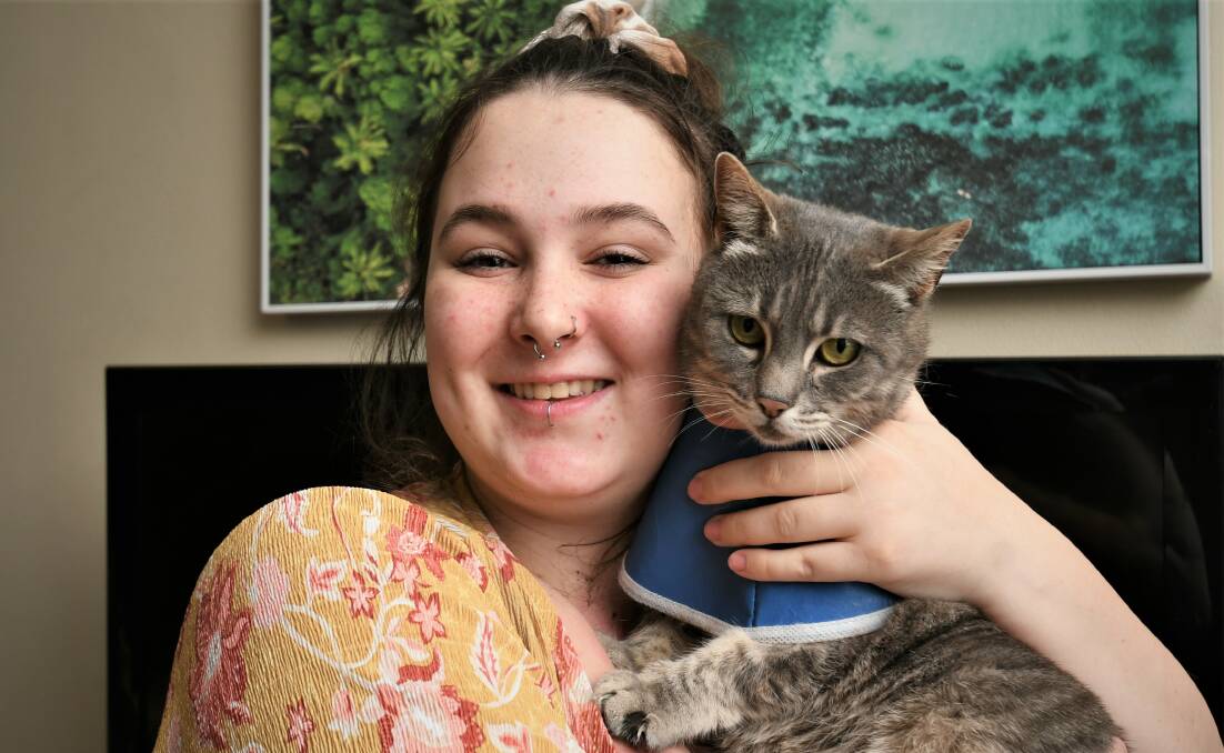 HOME SAFE AND SOUND: Phoebe Barnes-King, with her pet cat, Mia, who has been reunited with her family. Photo: CHRIS SEABROOK.