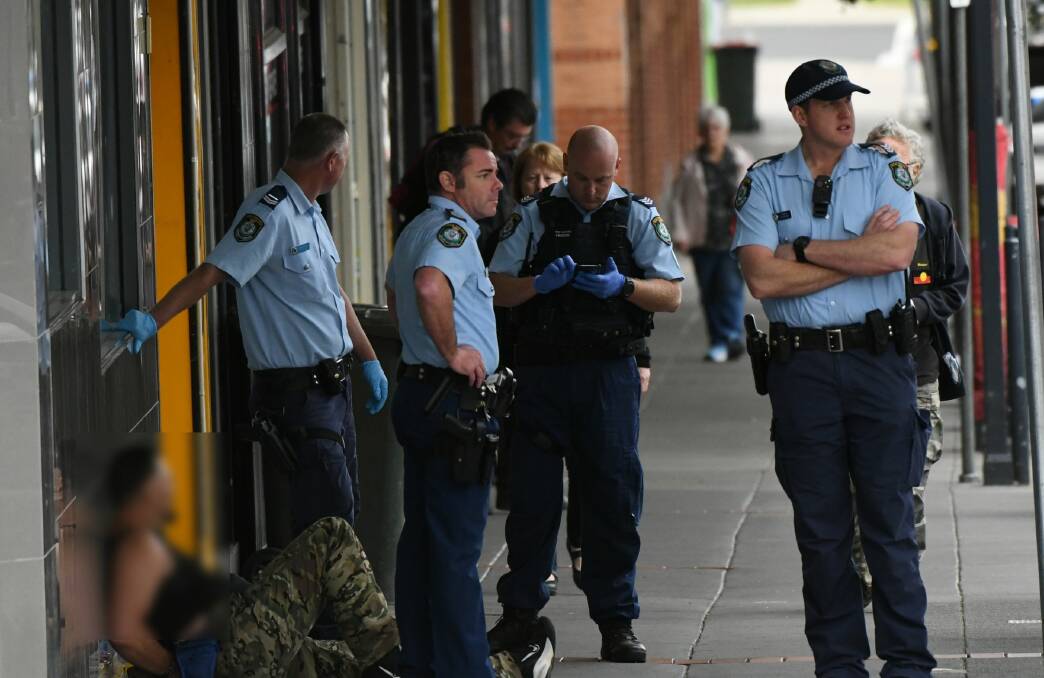 POLICE: Officers surround a 47-year-old man who allegedly threatened staff at a jewellery store on Tuesday morning, telling them he had a gun. Photo: CHRIS SEABROOK.