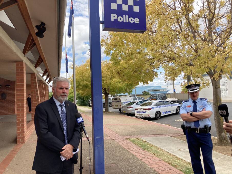 SIX CHARGED: Superintendent Peter O'Brien, speaks to the media following the arrest of six people outside, while Det Chief Inspector Luke Rankin looks on.