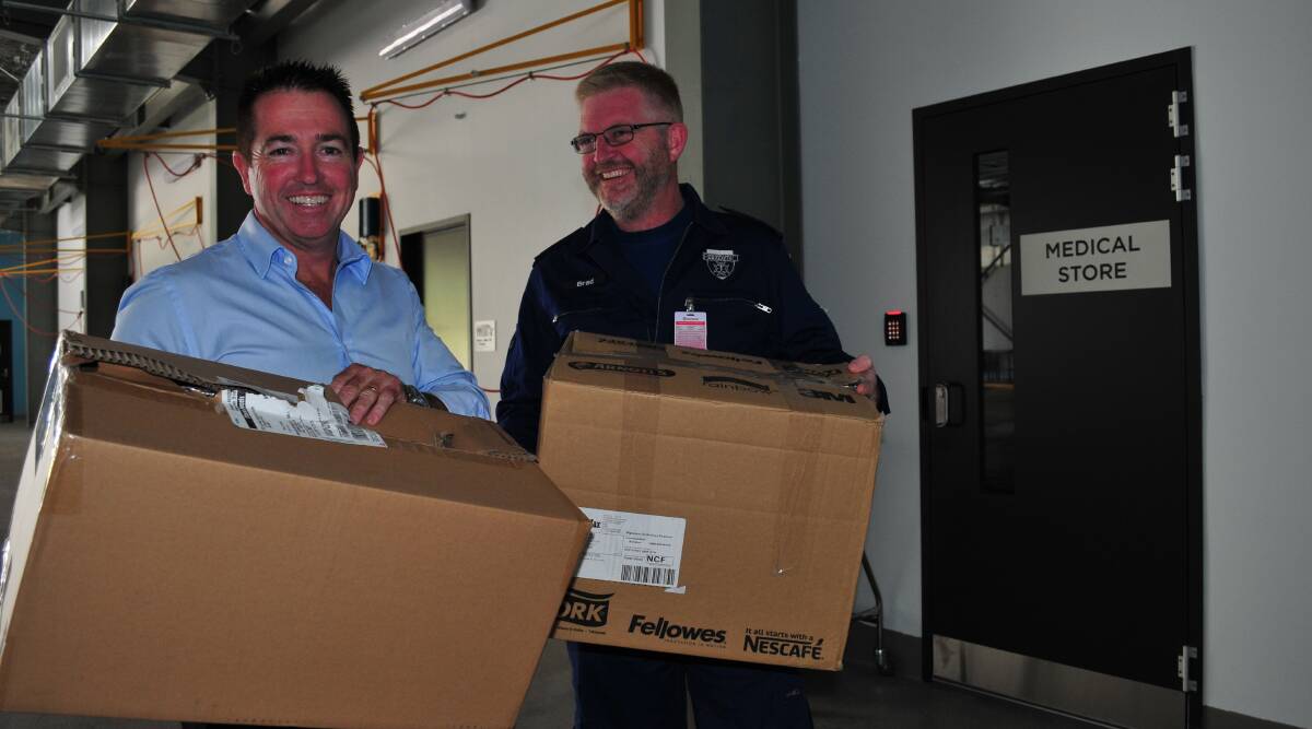 MOVING IN: Bathurst MP Paul Toole and NSW Ambulance Central West zone manager Superintendent Brad Porter with stationery supplies arriving at the new ambulance station. Photo: JACINTA CARROLL
