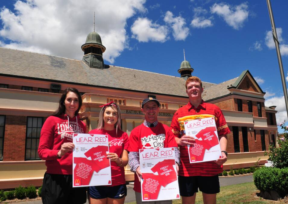 WEAR RED:Sally Hennessy with Abbey Kemp, Ken Barwick, school principal, and Bradley Fearnley, will be wearing red on Friday.