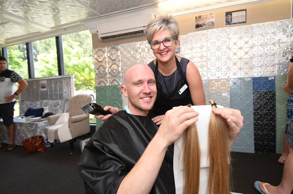 A CLOSE SHAVE FOR GOOD CAUSE: Mandy Wilding (Daffodil Cottage Wig Library) with Brendan Sauer (32yrs) with his long locks for a child's wig. Photo:CHRIS SEABROOK  121818cwigs