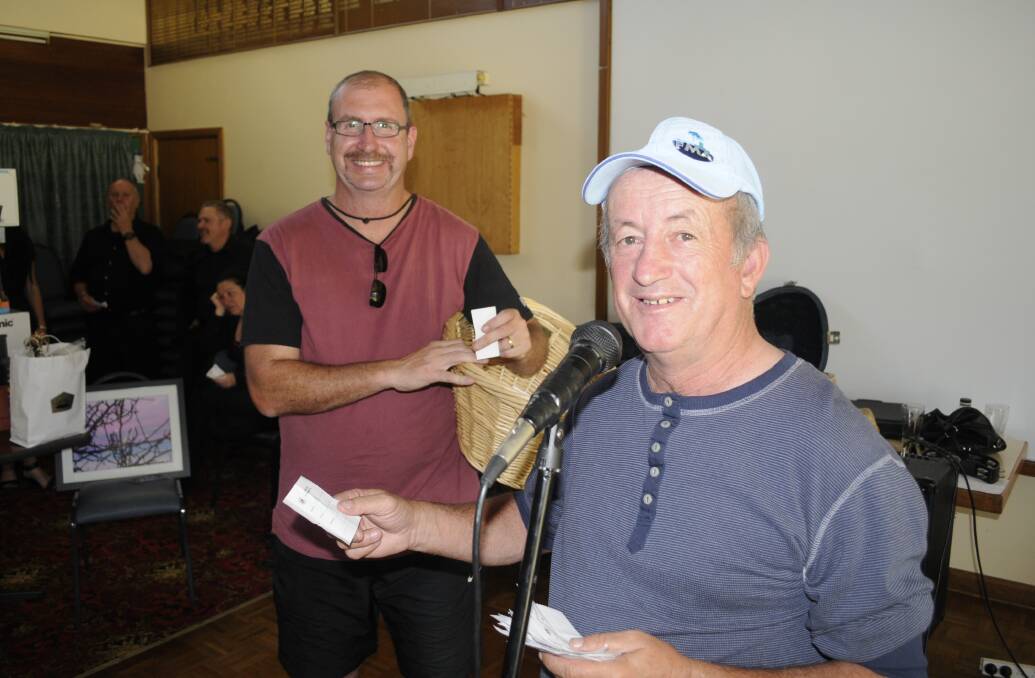 CHRISTMAS APPEAL: Bobby Bourke with help from Steve Ellery announcing lucky door prizes at the  Christmas Miracle  Appeal.