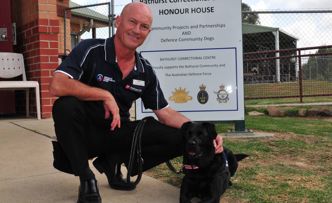 LIFE SAVER: Veteran, Michael Nobes, with his service dog Lola, returned to the PTSD Service Dog  Graduation in Bathurst on Thursday where he spoke about the program and the work of inmates in saving the lives of war veterans.