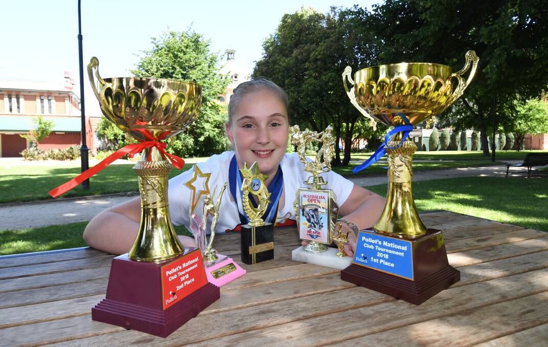 DETERMINATION: Reshia Winfield, 12, with some of her trophies from a recent martial arts club championship weekend. Photo: CHRIS SEABROOK