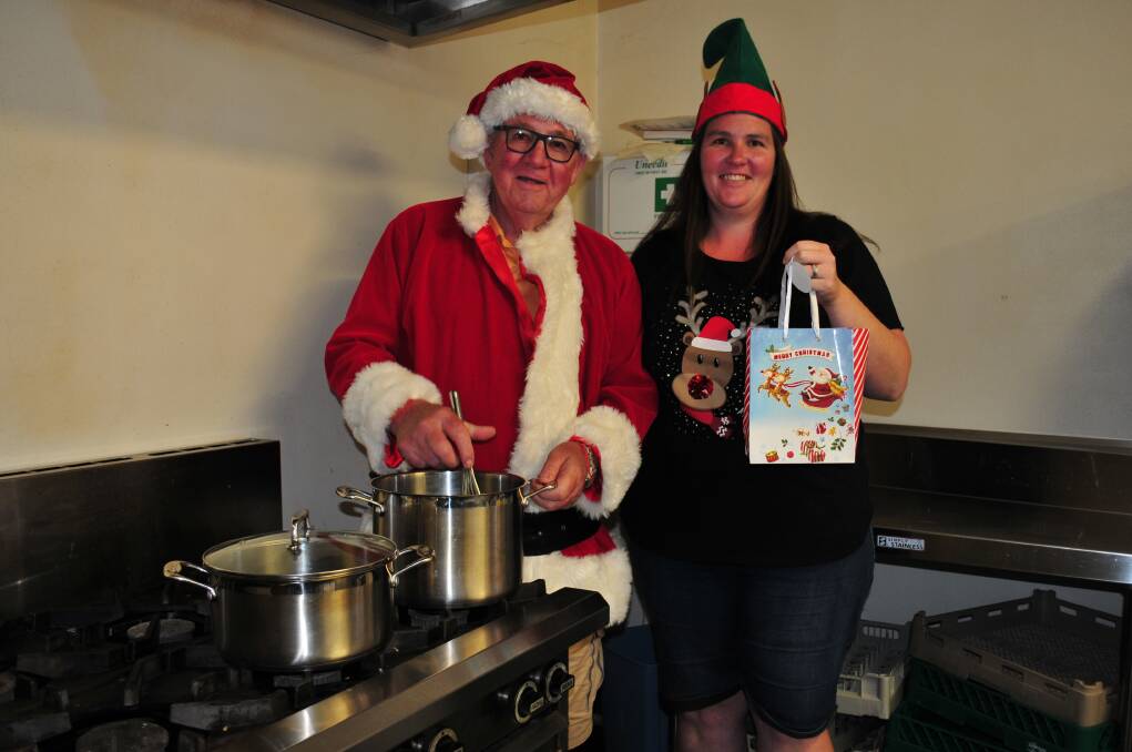 CHRISTMAS LUNCHEON: Barney Rumble, with his daughter, "Elf in Charge" Kathleen Clarke, are busy preparing for the Community Christmas luncheon.