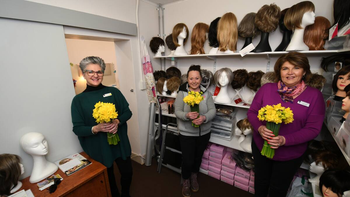TRUE COLOURS: Wig Library volunteers Mandy Wilding (left) and Heather Larnach (right) with florist Vanessa Pringle.