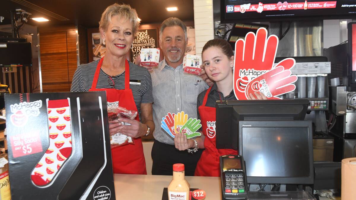 MCHAPPY DAY: Leeanne McCulkin, Todd Bryant (licensee) and Brittany Wood, with some of the McHappy Day merchandise.