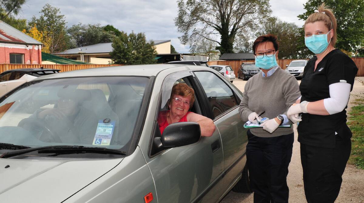 IMMUNISED: Barbara Robson getting her flu shot from Dr Anh Tran and practice nurse Belinda Livingston in the drive-through flu clinic at Loxley House.