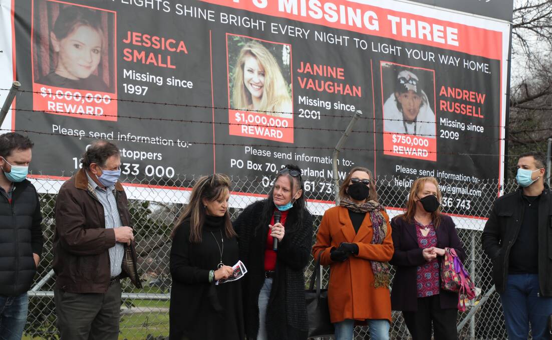 PLEASE HELP THEM: The families and friends of Jessica Small, Janine Vaughan and Andrew Russell with supporters, standing in front of the banner, at Carrington Park.