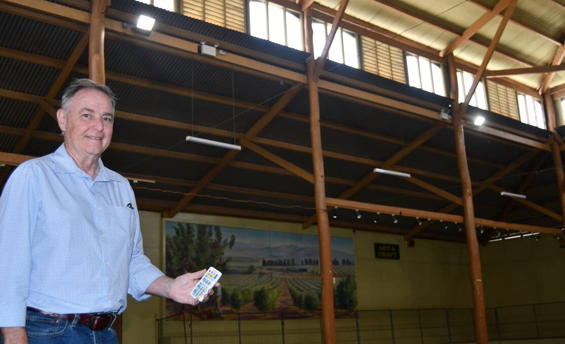 NEW LIGHTING: Andrew Fletcher, in one of the showground pavilions, holding the remote control for the new lighting system.