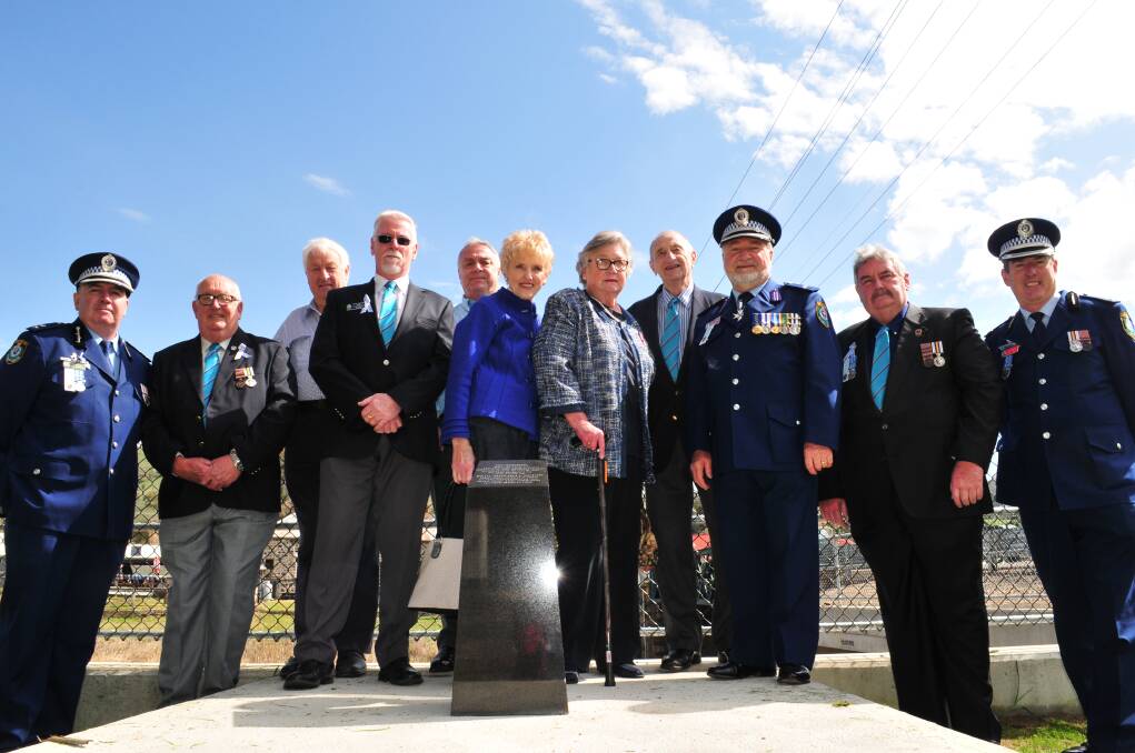 NEVER FORGOTTEN: Current and former serving members of the NSW Police Force, joined with civilian staff and members of the community at the rededication of Paul Quinn's memorial, at Perthville, on Friday.