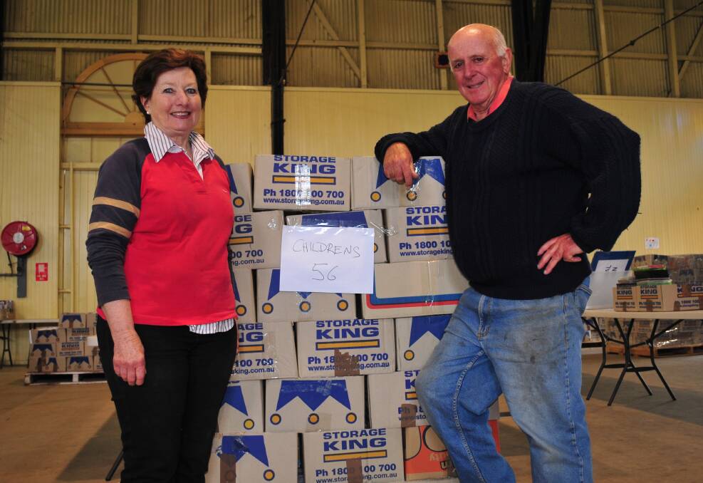BIG WEEKEND: Celia and Alex Ferguson with a crate of children's books, ready to be unpacked for this weekend's book fair.