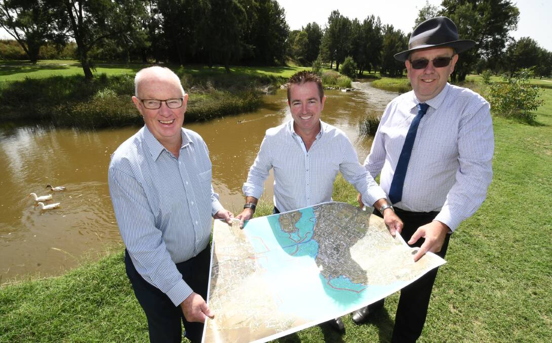 FINAL PIECE: Bathurst mayor Graeme Hanger, Bathurst MP Paul Toole and council's director of engineering services Darren Sturgiss looking over local flood levee maps. Photo: CHRIS SEABROOK 021319clevee1