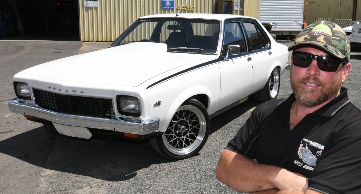 AUSSIE ICON GONE: Dale Cranston with a 1970 model Holden Torana he has worked on at his business, Bathurst Mufflers. Photo: CHRIS SEABROOK 021820cholden1