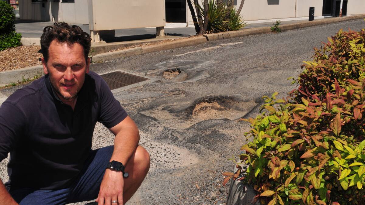 ONGOING ISSUE: Councillor Jess Jennings in front of the potholes last week. On Thursday the potholes were filled with sand as a makeshift solution.