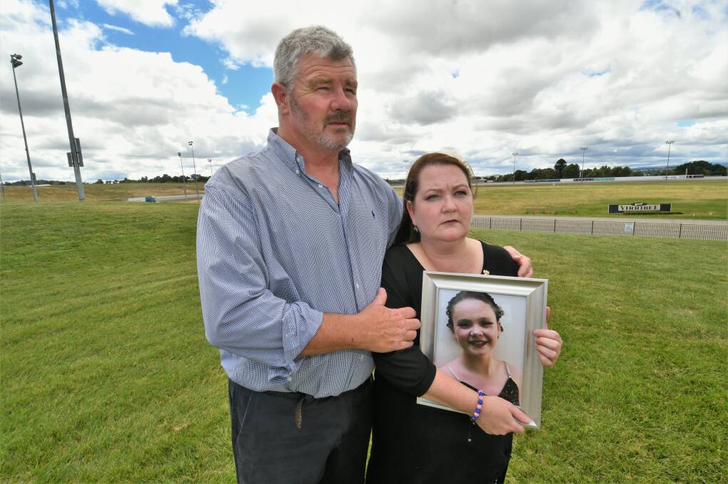 ALWAYS BE KIND: Tilly's parents, Murray Rosewarne and Emma Mason, holding a photo of Tilly. Photo: CHRIS SEABROOK.