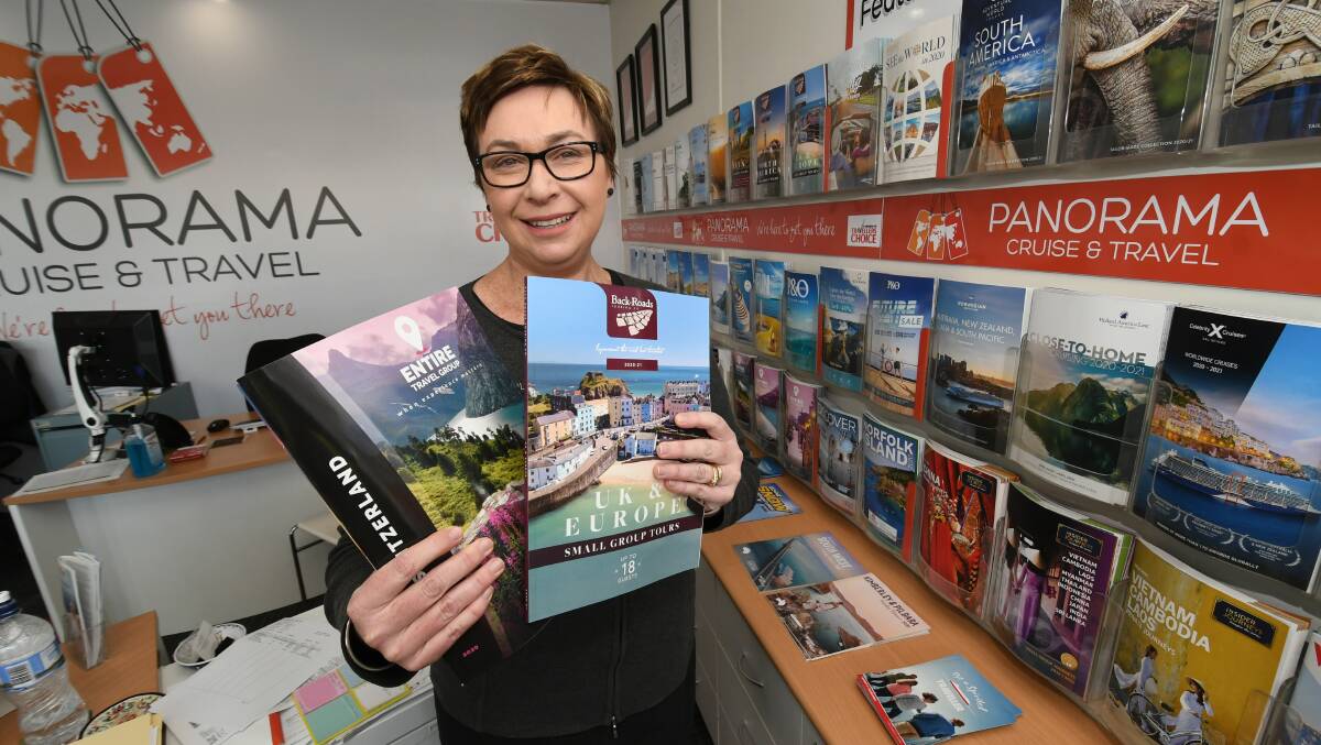 REUSE, RECYCLE: Caroline Sage with some of the travel brochures Panorama Cruise and Travel is giving away for school projects, instead of just throwing them out.