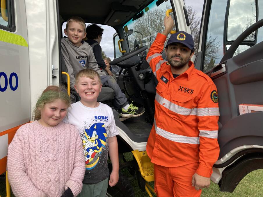 FUN DAY FOR FAMILIES: Dillon Budhiraja, from Bathurst SES giving Flynn Black (in driver's seat) and Taylor and Jaxon Gearon a look inside the SES truck on Saturday.
