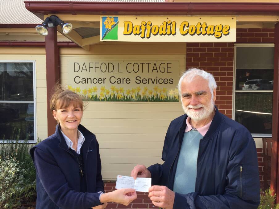 Nurse Manger of Daffodil Cottage, Mooreen Macleay accepts a cheque for $1340.00 from the vice-president of the Bathurst Bridge Club, Alan Sims.