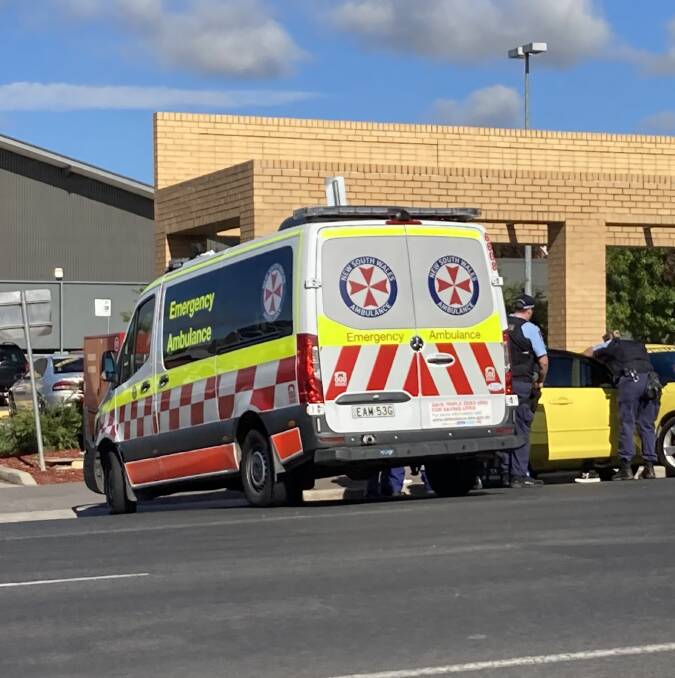 AT THE SCENE: Paramedics and police assisting at the scene where a woman's foot was run over on Monday morning.