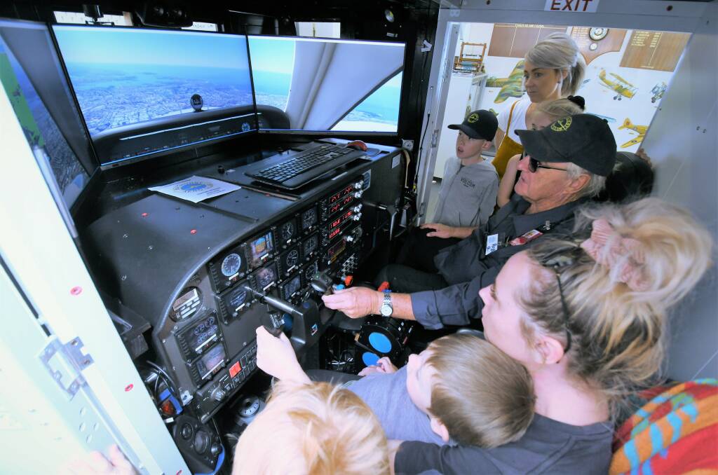 GREAT DAY: Pilot Rob Quinn shows the workings of a Cessna 172 S Flight Simulator at the Bathurst Aero Club's open day on Sunday. 
