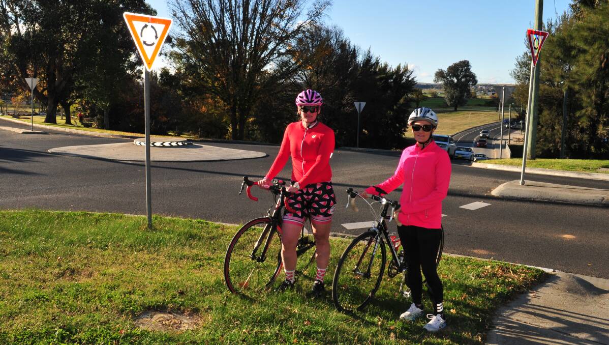 PLEASE TAKE CARE: Bathurst cyclists Renne Covington and Melissa Rajkovic at the roundabout where Ms Rajkovic was nearly hit by a car last Friday.