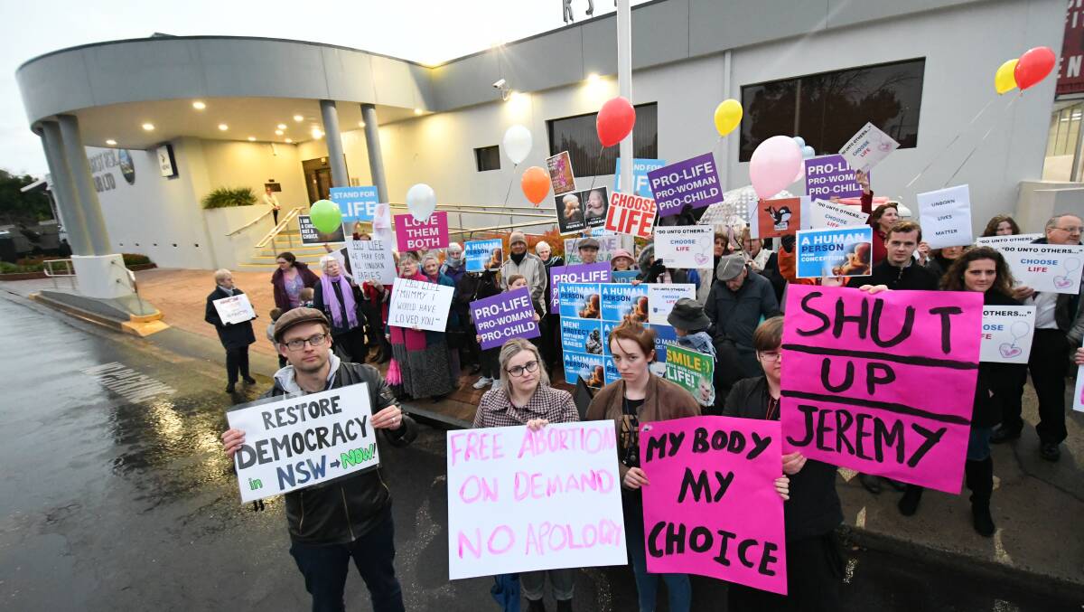CALL TO ACTION: Organised by Jeremy Brown, around 60 people attending the call to action, urging politicians to choose life and reconsider the pending bill, while a small group advocate pro-choice next to him.