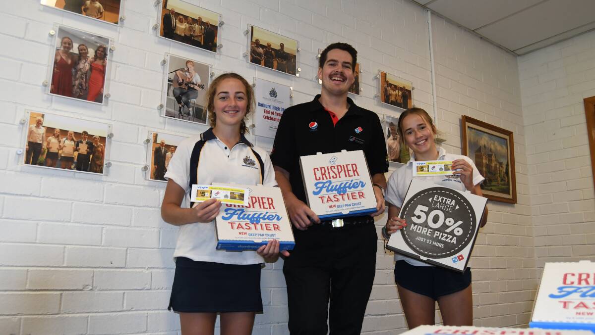 VIVO LA PIZZA: Domino's operations manager Thomas Dibley (centre) with Bathurst High School Year 11 students Bronte O'Brien and Zoe Peters.