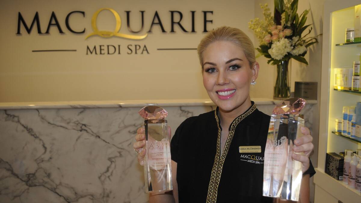 NATIONAL AWARDS: Karla McDiarmid, with the two national titles her medi spa won in the 2017 Australian Beauty Industry Awards.