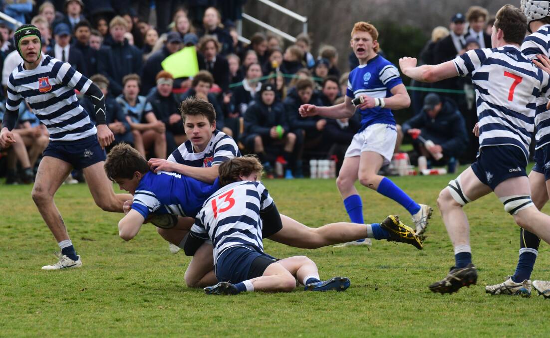 TROUBLE: It was an action-packed game between Kinross and Stannies. Photo: JUDE KEOGH.