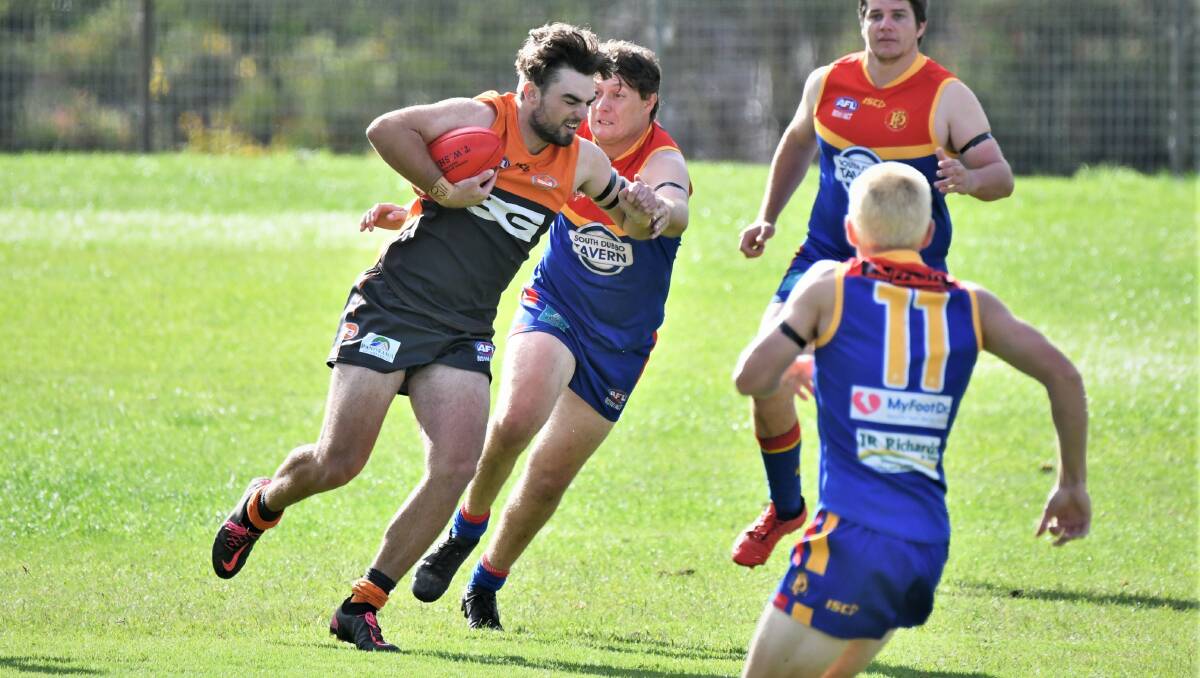 PUSHING ON: Nic Broes looks to evade Dubbo defender Bailey Edmunds during the Bathurst Giants' close contest at George Park 1. Photo: CHRIS SEABROOK