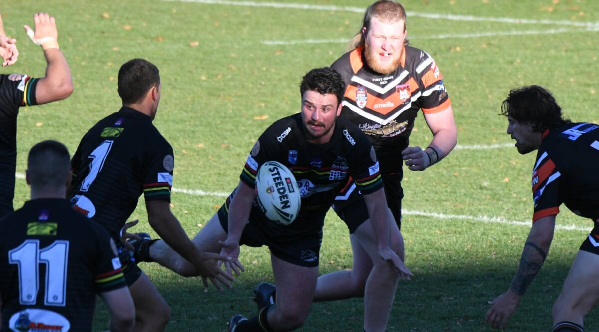 HERE YOU GO: Jake Betts passes to Josh Rivett during the recent game against Workies. Photo: CHRIS SEABROOK