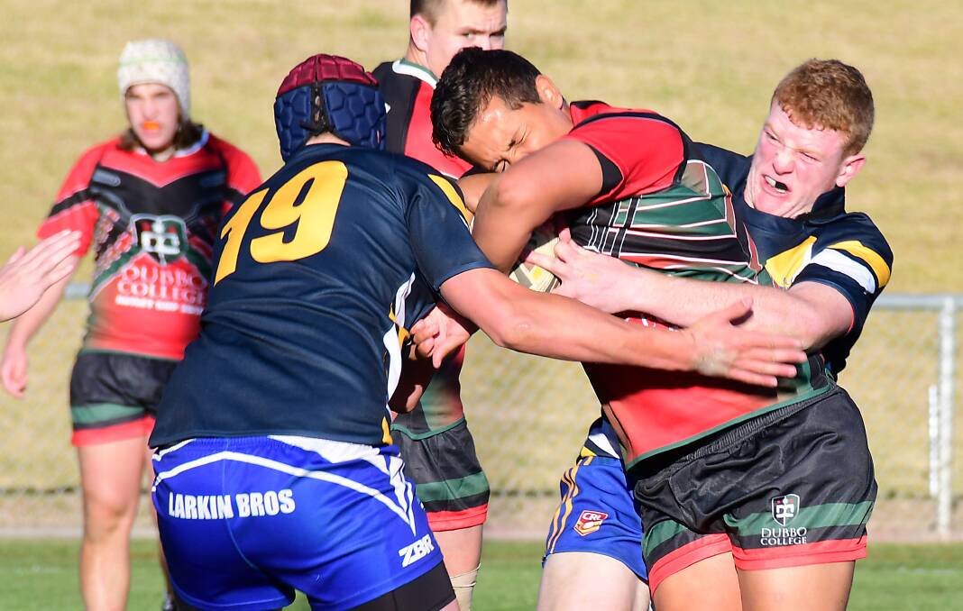 WRAPPED UP: Bathurst High School's Brad Fearnley makes a tackle during a close contest against Dubbo College. Photo: BELINDA SOOLE