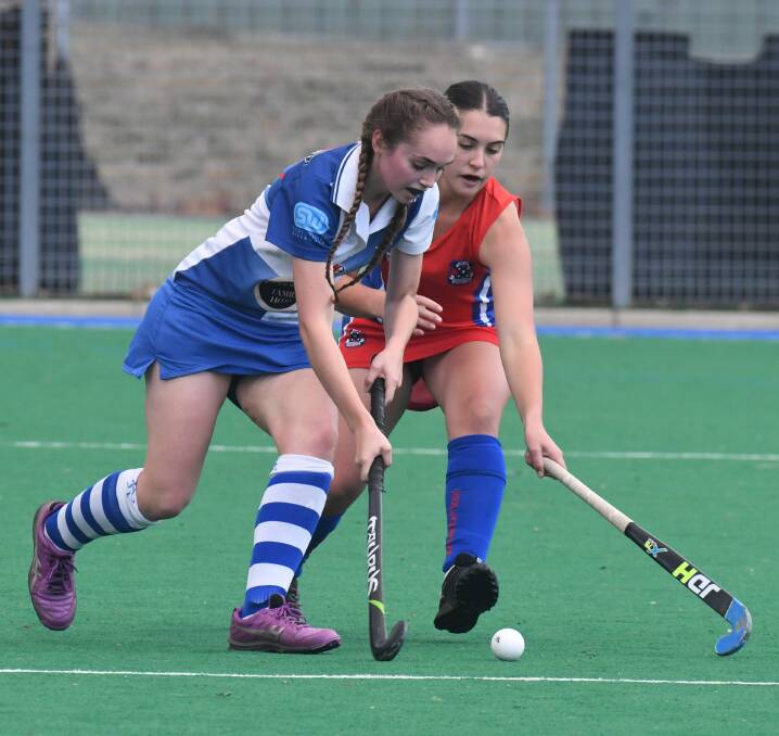 WINNING START: St Pat's Premier League Hockey debutant Georgie McGregor looks for a path around a Confederates opponent on Saturday. St Pat's won the contest 3-1 over the hosts. Photo: JUDE KEOGH